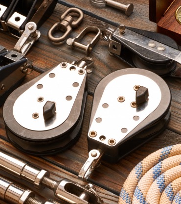 Sailing yacht rigging equipment on wooden background